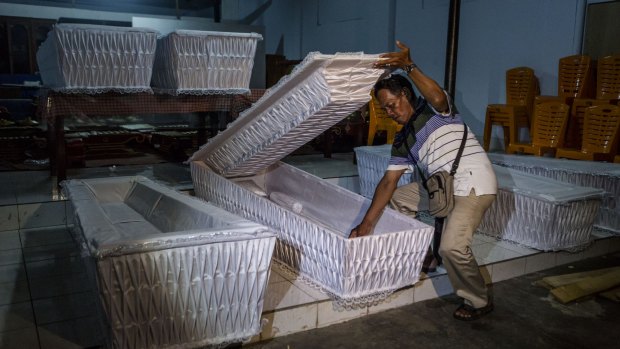A man prepares coffins before loading them into a truck ahead of the executions of the death row inmates in coming days. 
