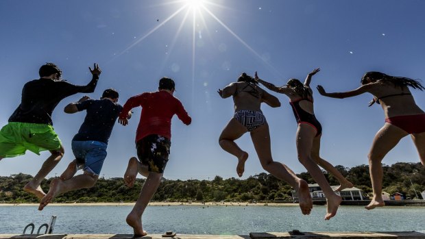 Fun in the sun: Swimmers beat the heat at Black Rock pier.