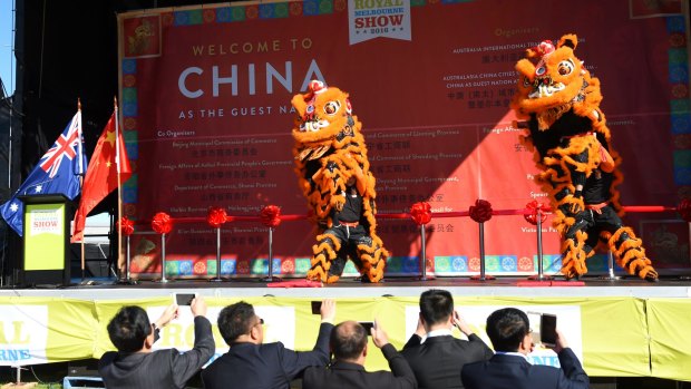 Lions perform on stage to welcome Chinese guests to the Royal Melbourne Show.
