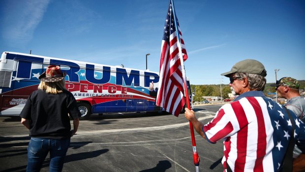 Supporters stand near Donald Trump's bus during a campaign stop last October in Alabama, home state of the writer's cousin.