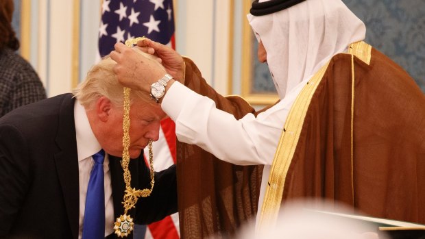 Saudi King Salman presents President Donald Trump with the Collar of Abdulaziz Medal in  Riyadh.