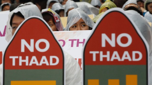 South Korean protesters attend a rally in Seoul to oppose a deployment of THAAD last July.
