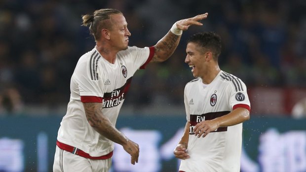 AC Milan's Philippe Mexes (left) celebrates with his teammate Agustin Jose Mauri.