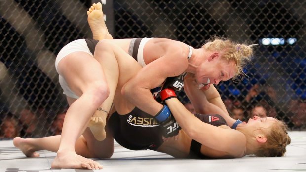 Holly Holm knocks down Ronda Rousey in UFC 193 at Etihad Stadium.