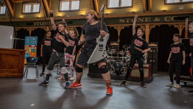 Brent Hill with younger cast members during rehearsals for School of Rock in Melbourne.