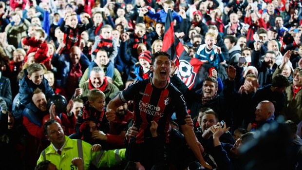 Bournemouth captain Tommy Elphick celebrates with fans.