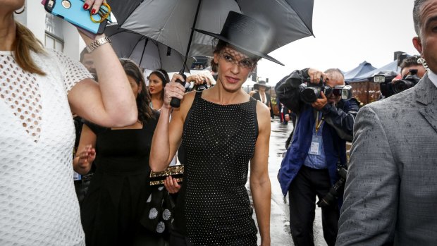 Hilary Swank dodging a shower at Derby Day.