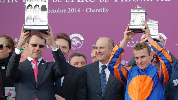 Ryan Moore, right,  owner Mikel Tabor, centre, and trainer Aidan O'Brian hold their trophies on the podium.