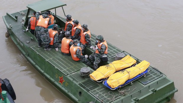 Rescuers transport the bodies of victims on the Eastern Star.