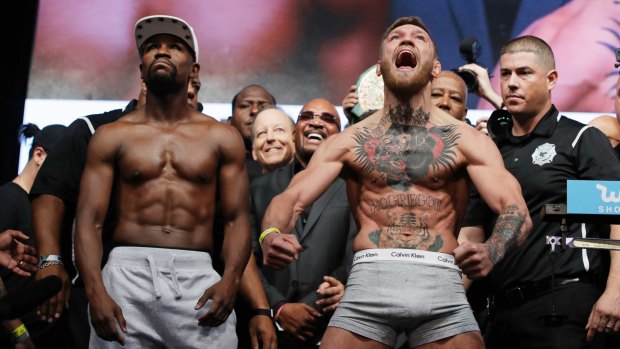 Money, money, money: Floyd Mayweather and Conor McGregor at the pre-fight weigh-in.
