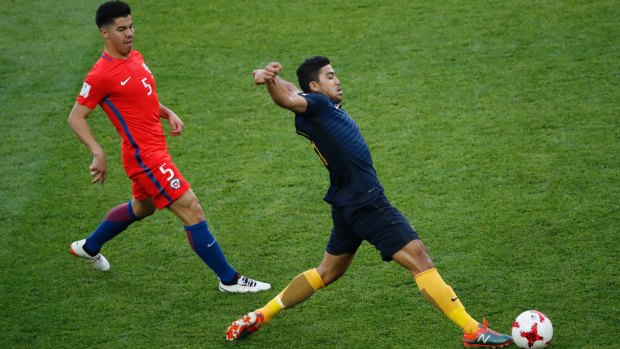 Australia's Massimo Corey Luongo (right) lunges to control the ball with Chile's Francisco Andres Silva Gajardo a step behind.