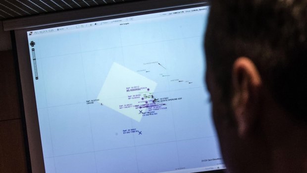 An officer looks at a monitor showing ships navigating the area where a boat believed to be crowded with perhaps as many as 700 migrants capsized in the waters north of Libya.