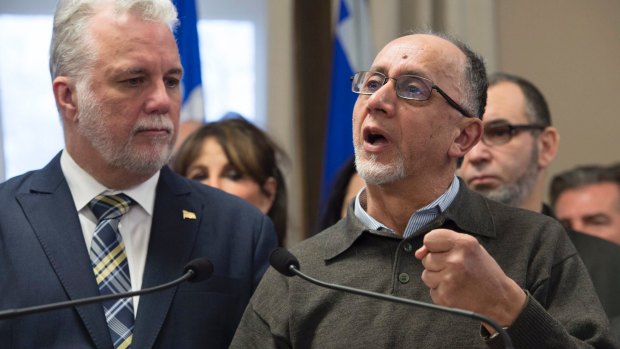Benabdallah Boufeldja, right, co-founder of the Islamic cultural centre, responds to reporters questions as Quebec Premier Philippe Couillard, left, looks on.