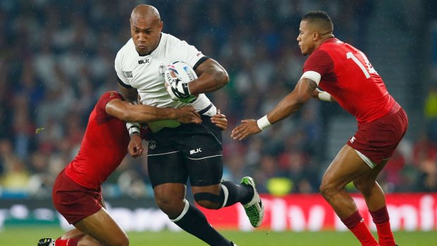 Nemani Nadolo of Fiji cuts a path through England players in the World Cup opening match at Twickenham.