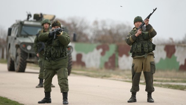 Troops under Russian command fire on Ukrainian troops at the Belbek airbase as part of the annexation of Crimea in March 2014. Two years on, tensions in the region are again on the rise.