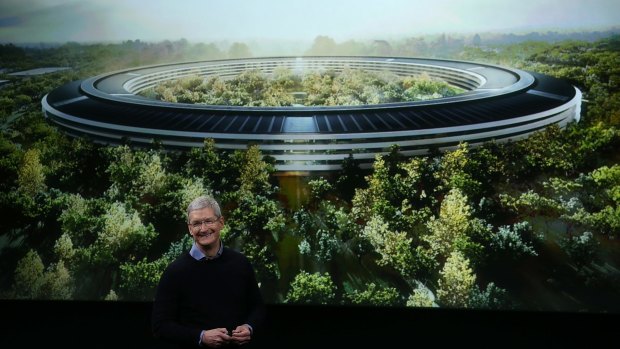 Apple CEO Tim Cook in front of an artist's impression of the new campus, Apple Park. 