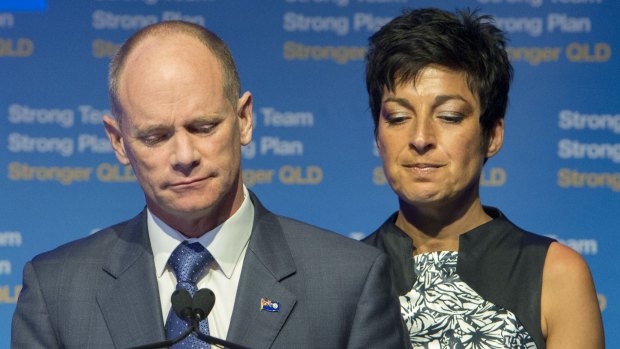 Campbell Newman speaks to LNP supporters, flanked by his wife Lisa.