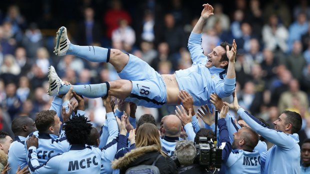 Manchester City's Frank Lampard is thrown in the air by teammates after his final game.