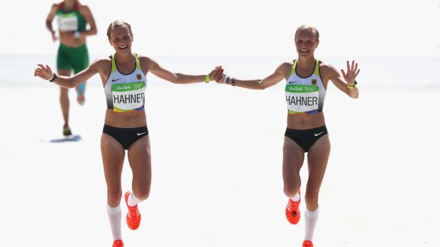 Anna Hahner (L) of Germany and her sister Lisa Hahner approach the finish line during the Women's Marathon on Day 9 of Rio 2016.
