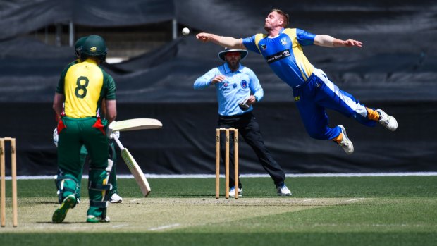 ACT bowler Sam Taylor dives for a catch during their Kingsgrove Cup match against Campbelltown-Camden at Manuka Oval on Sunday.