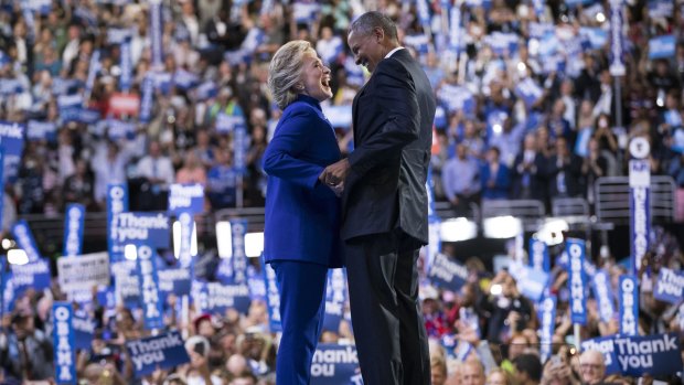 Hillary Clinton joins President Barack Obama on stage after he spoke at the Democratic National Convention in Philadelphia.
