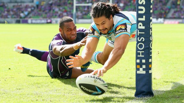 Kevin Gordon scores a try for the Titans in a 2014 match against the Melbourne Storm.