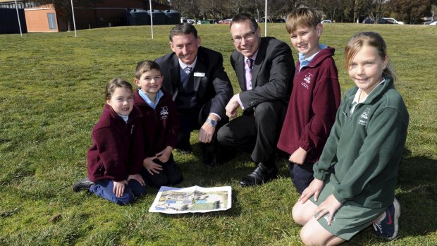 At the site for the new centre are, from left, Erin Kemp 6, Tyler Mullan 5, St Anthony's principal Greg Walker, Tim Smith from the Catholic Education Office, Ike Goddard, 11 and Abi McIntyre, 11.