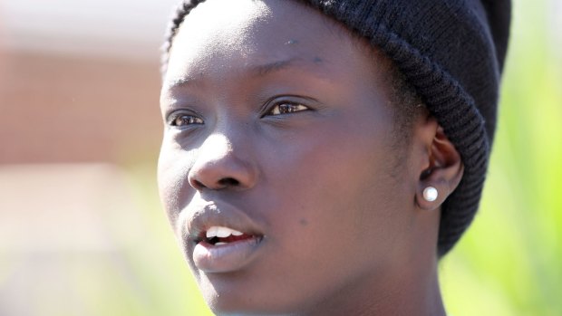 Akoi Chabiet, 19, speaks outside her family home about the loss of her three younger siblings.