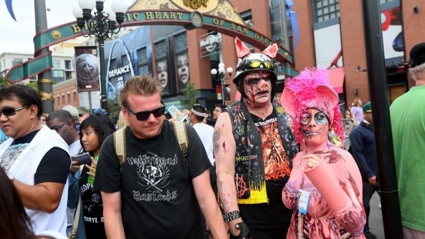 Fans display their costumes along Fifth Avenue in San Diego's Gaslamp Quarter during last year's Comic Con.
