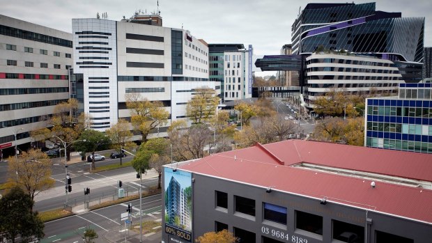 Melbourne City Council has approved a 15-level apartment tower where the building with the red roof now sits. Royal Melbourne Hospital is in the background.