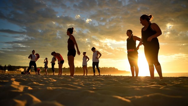 A group of women exercise at Bondi beach before temperatures reached 38 degrees.