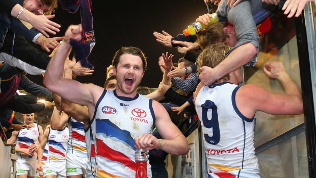 Adelaide's Patrick Dangerfield high fives fans after winning the elimination final against the Western Bulldogs.