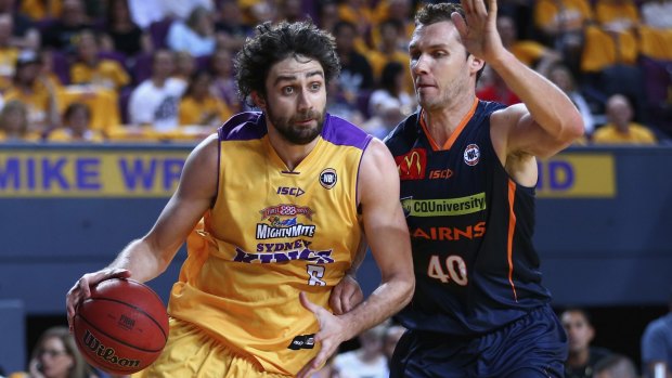 In control: Julian Khazzouh of the Kings charges past Alex Loughton of the Taipans.