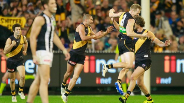 Jack Riewoldt (right) of the Tigers leaps for joy after kicking a goal in the final quarter. 