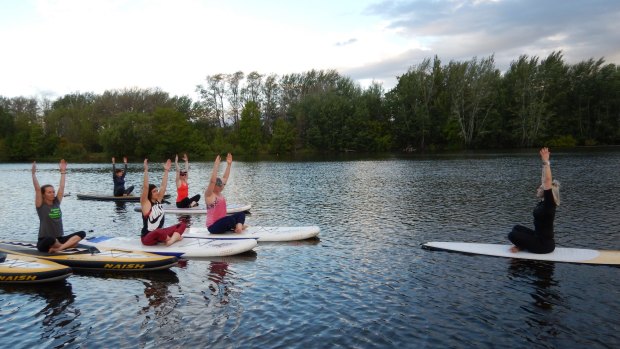 Stand-up paddleboard yoga with Jo Flynn from Joga Yoga on Lake Burley Griffin.