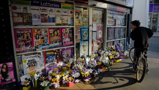 Memorials left outside the Lin family's newsagency after the murders.