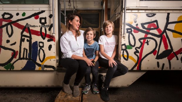 Fiona Larwill and her sons Henry, 9, and James, 13, with the tram painted by David Larwill in 1986.