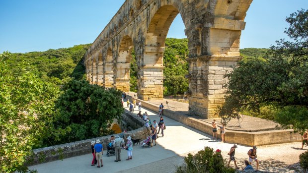 Pont du Gard, a mighty aqueduct bridge rising over three arched tiers, built by first-century Romans.
