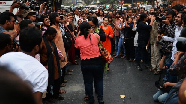 Two Indian women share a kiss during the protest in Delhi on Saturday.