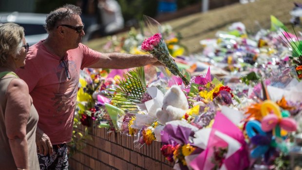 A couple pay their respects at Dreamworld on Thursday.