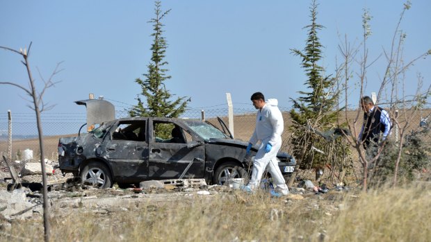 Police forensic officers work at the scene after suicide bombers blew themselves up in Haymana in the outskirts of Ankara, Turkey, on Saturday.