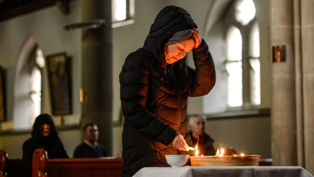 Helen Donnellan lights a candle at the vigil for Andrew Chan and Myuran Sukumaran, who face execution in Indonesia for drug smuggling.