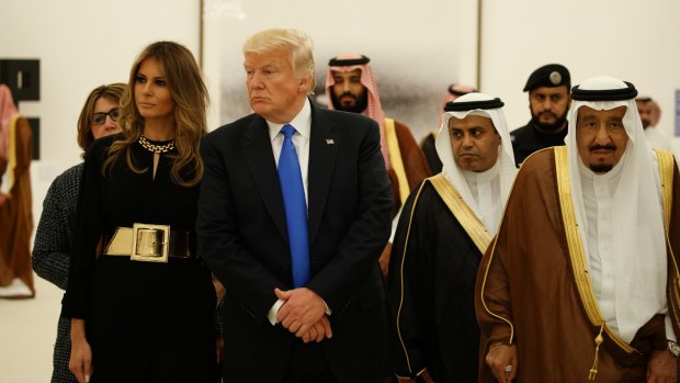 President Donald Trump and first lady Melania Trump visit an art exhibit with Saudi King Salman at the Royal Court Palace.