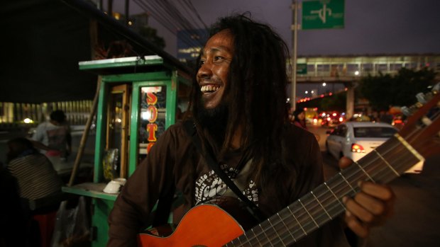 Bambang 'Ho' Mulyono performs on the streets of Jakarta. He is one of three buskers who feature in the documentary <i>Jalanan</i> by Daniel Ziv.