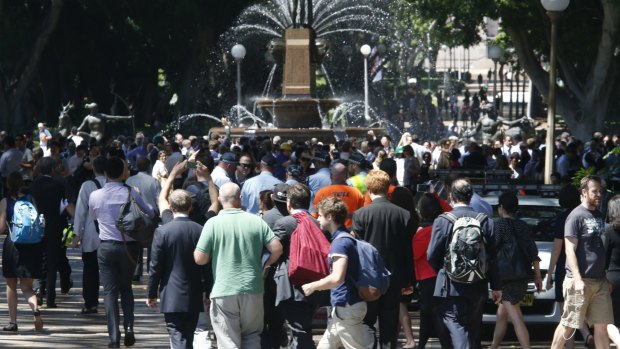 People are evacuated to Hyde Park during a siege in Martin Place. 