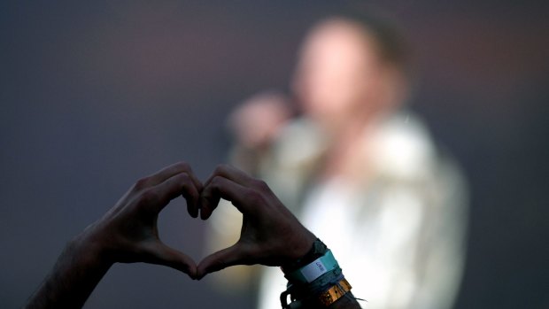 Those in the crowd waved rainbow flags and made love heart symbols with their hands.