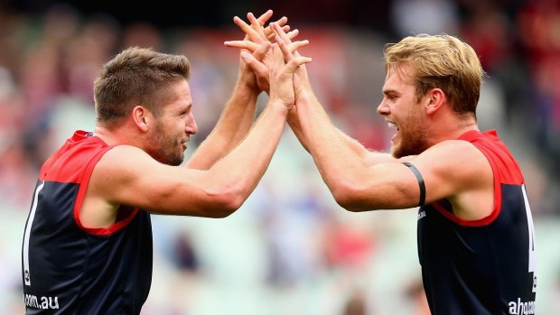 Jesse Hogan and Jack Watts of the Demons celebrate a goal.