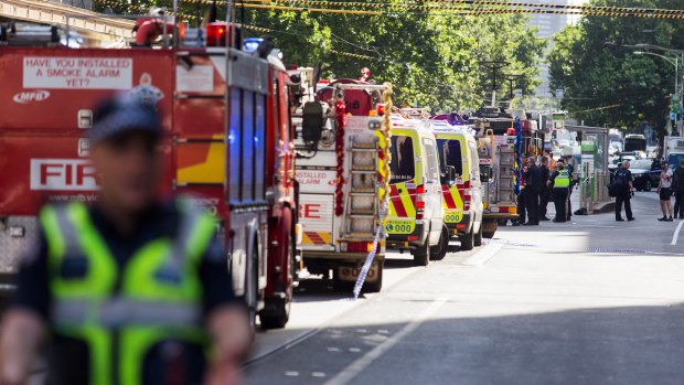 Ambulances and fire trucks line the street.