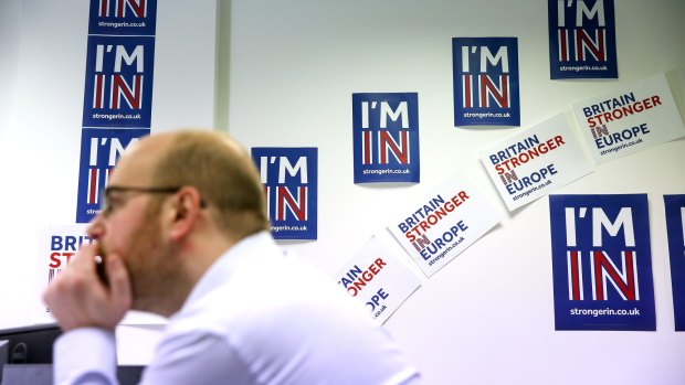 An employee works in front of campaign posters at the Britain Stronger In Europe campaign offices in London.