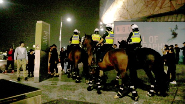 Mounted police patrol Federation Square.